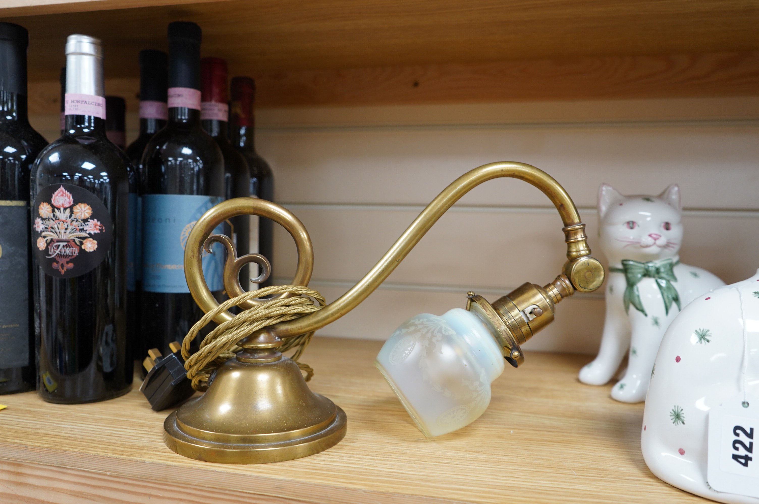 A brass piano lamp with original acid etched miniature Vaseline shade, circa early 20th century, wired, 20cm high, projection 43cm. Condition - fair to good, some minor nibbles to the shade